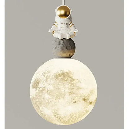 A decorbites astronaut lunar pendant light featuring a white astronaut figurine with gold helmet over an illuminated moon globe