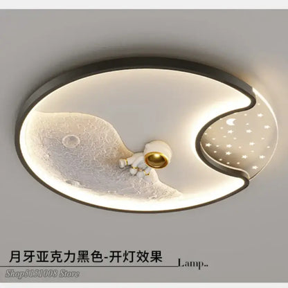 Modern black framed decorbites astronaut moon acrylic ceiling lamp featuring oval moon surface and white astronaut figurine