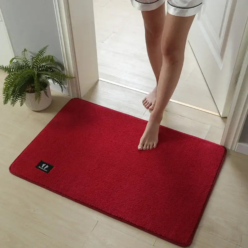 A vibrant red plush rectangular decorbites bathroom mat with soft texture and super non-slip quick drying surface