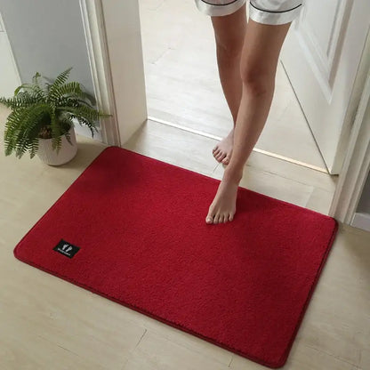 A vibrant red plush rectangular decorbites bathroom mat with soft texture and super non-slip quick drying surface
