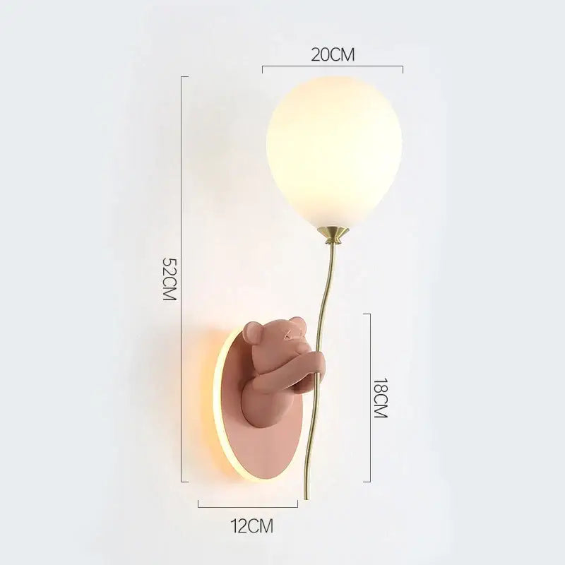 Pastel pink DecorBites bear artistic wall lamp holding a frosted glass balloon with brass stem for kids room decor