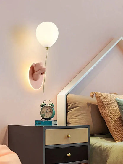 Decorbites bear artistic kids wall lamp featuring a pink hand holding a soft white balloon-shaped light fixture