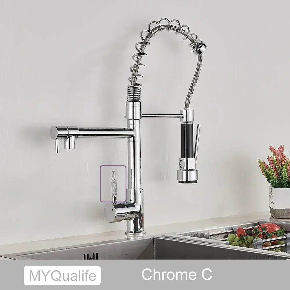 Chrome-finished decorbites black brass kitchen faucet with flexible coiled hose and black accents on pull down spray head