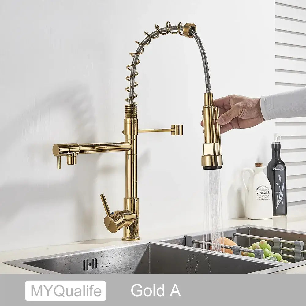 Decorbites black brass kitchen faucet with dual gold-colored spout and flexible pull-down spray head in sleek design