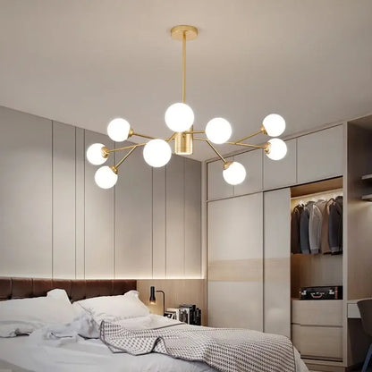 Gold-toned decorbites black chandelier with multiple frosted glass globes for living room illumination