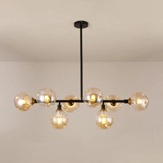 Modern black metal chandelier light type with clear glass globe bulbs and brass accents for dining room island use