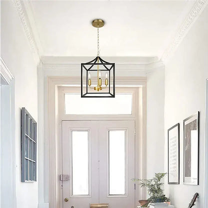 Decorbites black farmhouse chandelier pendant light with black metal lantern style and brass accents featuring four bulbs