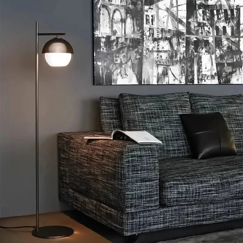 Modern floor lamp with a sleek brushed bronze dome shade and slender metallic pole from DecorBites black glass ball collection