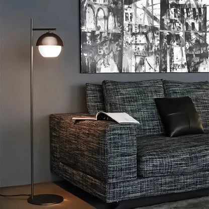 Modern floor lamp with a sleek brushed bronze dome shade and slender metallic pole from DecorBites black glass ball collection
