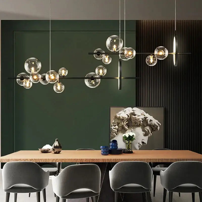 Modern black glass ball led pendant chandelier with sleek metal frame hanging above dining table by DecorBites
