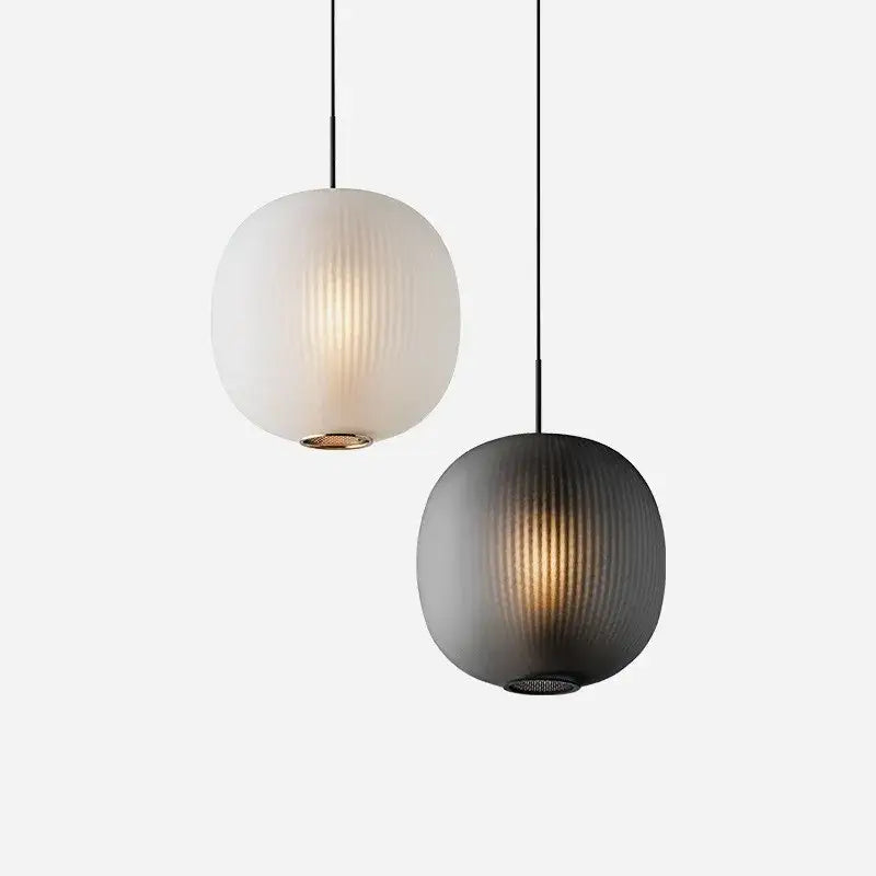 Two spherical pendant table lights with vertical ribbed glass ball shades in frosted white and matte black decorbites black glass
