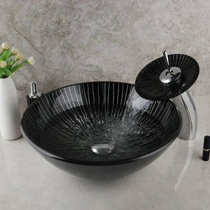 Decorbites black glass sink set featuring a black glass bathroom vessel sink with vertical white stripes and matching waterfall faucet