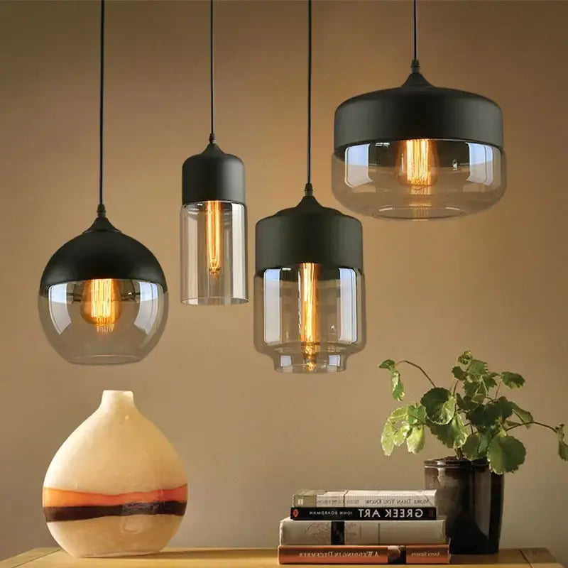Set of three DecorBites black glass pendant light fixtures with metal shades and exposed filament bulbs for modern decor