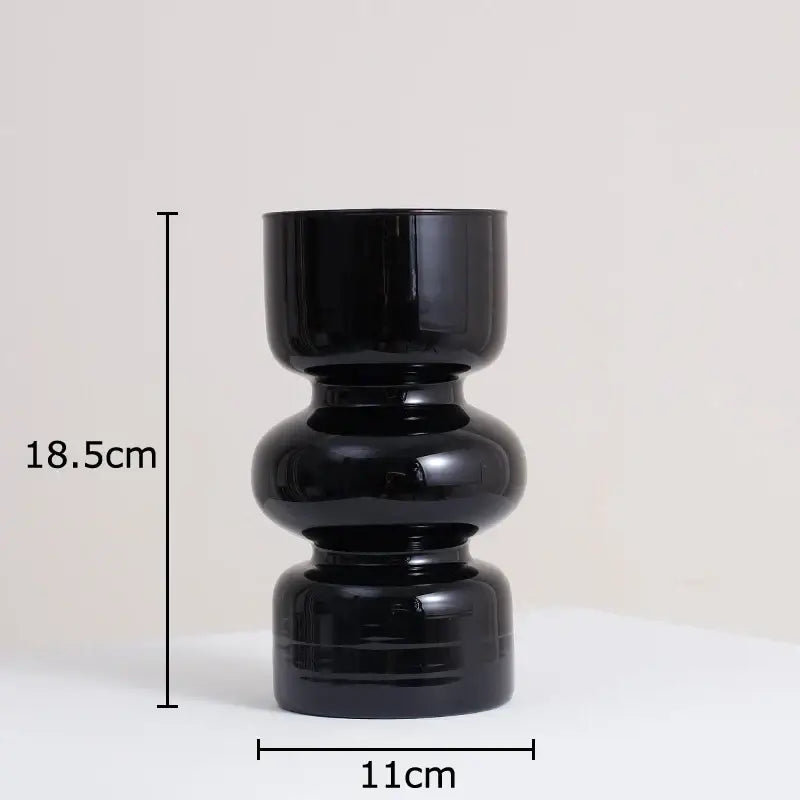 DecorBites black glass vase with stacked rounded segments in black ceramic and artificial flowers for stylish decor