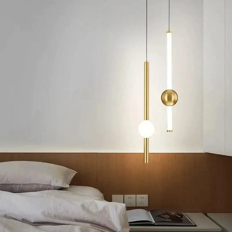 Modern gold-toned decorbites black gold ceiling pendant with sleek cylindrical and spherical designs for bedroom lighting