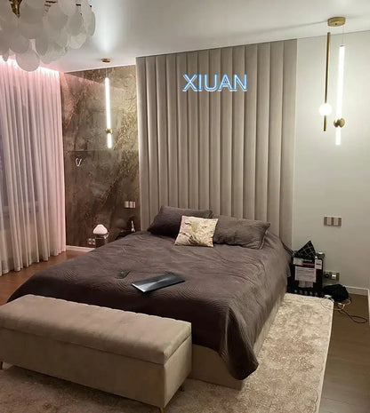 Beige upholstered bench with tufted top and slender legs paired with decorbites black gold ceiling pendant light