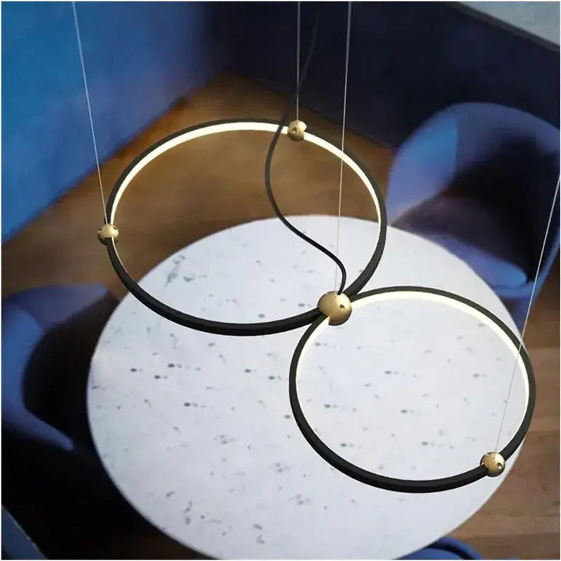 Modern black gold chandelier by decorbites featuring sleek circular metal rings with minimalist italian design and led lighting