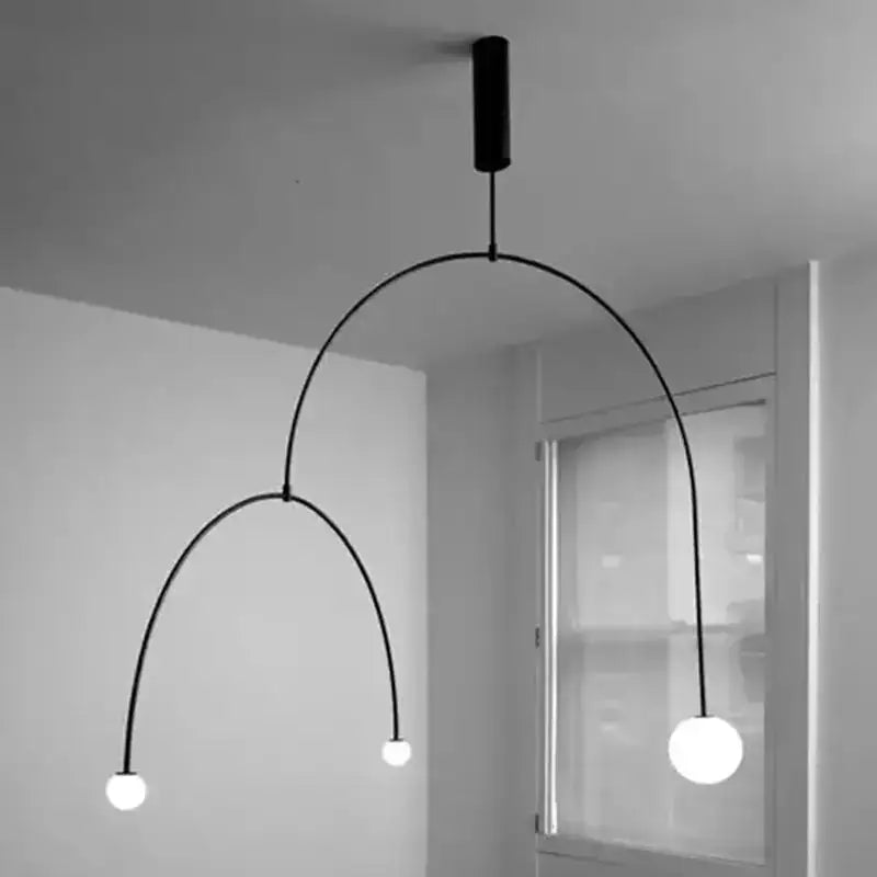 Black minimalist pendant light with two curved arms and spherical bulbs from decorbites black gold chandelier collection