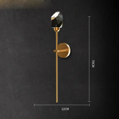 Gold-toned decorbites™ wall sconce light with faceted black crystal accent for bedroom corridor lighting