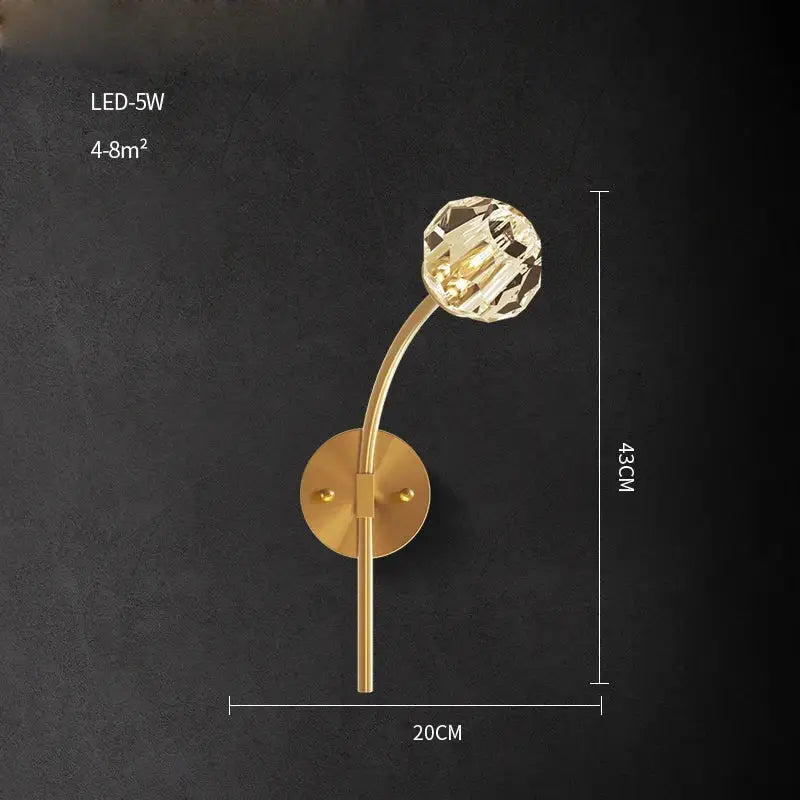 Gold-toned DecorBites wall sconce light with faceted crystal globe for bedroom and corridor illumination
