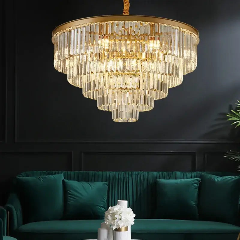 A decorbites black gold crystal ceiling chandelier with gold crystal frame and clear glass rods above emerald sofa