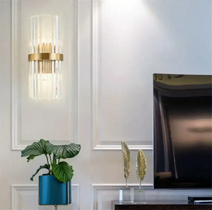 Gold-toned decorbites black gold crystal wall light with vertical rods and central brass ring for bedroom or living room