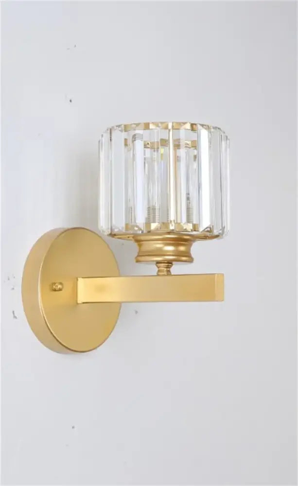 Decorbites black gold crystal wall light with gold finish and cylindrical faceted crystal shade for bedroom and living room
