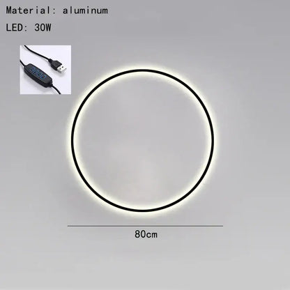 Circular aluminum DecorBites Black Gold wall light with sleek black frame glowing white illumination USB plug bedroom sconce