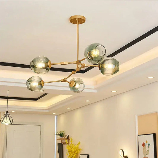 Modern brass chandelier with five translucent green glass globe shades in decorbites black gold glass pendant light