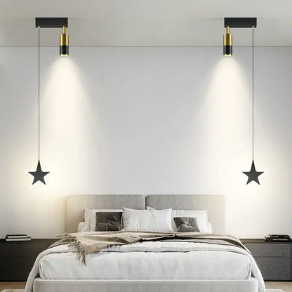 DecorBites black gold hanging pendant lamp features black star-shaped lights with gold accents above a bed for modern luxury