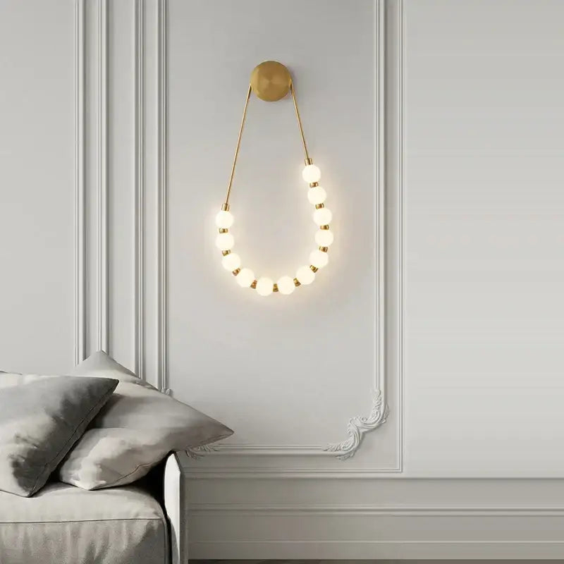 Gold-toned decorbites black gold led wall lamp sconce with warm spherical bulbs for bedroom and corridor lighting