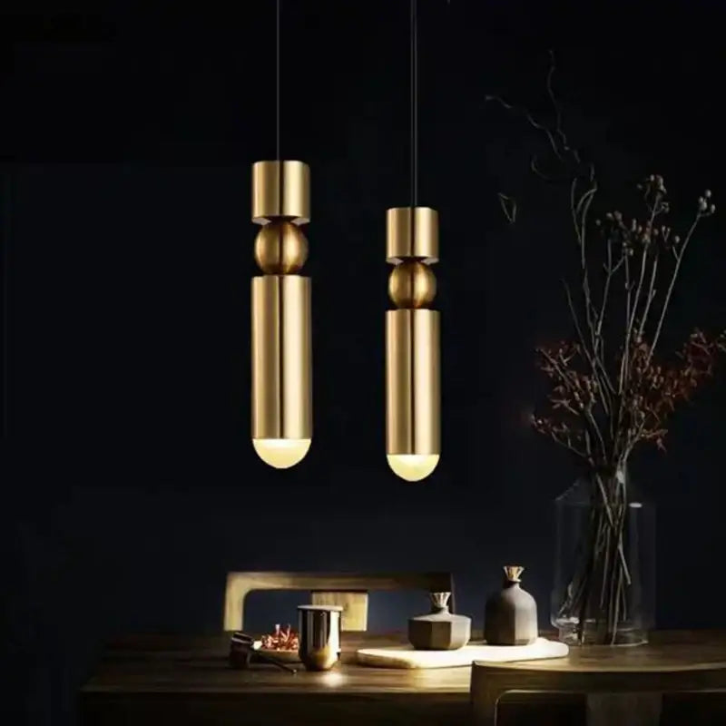 Two sleek gold led tube pendant lights from decorbites black gold chandelier hanging on black cords