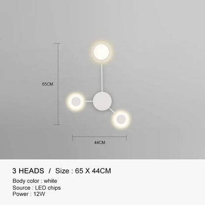 White minimalist wall lamp with three glowing led heads in a triangular pattern decorbites black gold led design