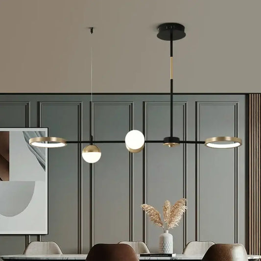 Decorbites black gold minimalist chandelier with three black and gold spherical bulbs for dining room decor
