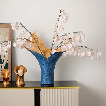 Blue ceramic vase with textured leaf design and gold interior accents in decorbites black gold resin handicrafts display piece