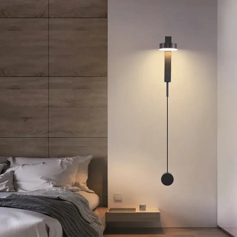 Modern decorbites black gold rotating wall lamp with sleek black circular light and hanging spherical element for bedroom