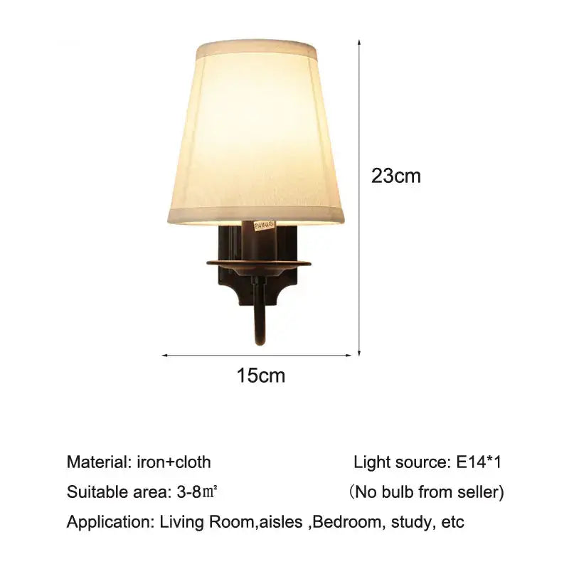 A warm-toned 23cm tall decorbites black iron wall lamp with beige fabric shade and dark iron base for indoor use