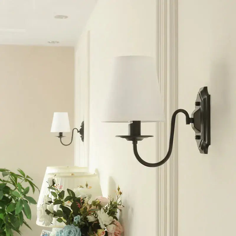 DecorBites black iron wall lamp with black wrought iron and white fabric shade for elegant rural bedroom decor