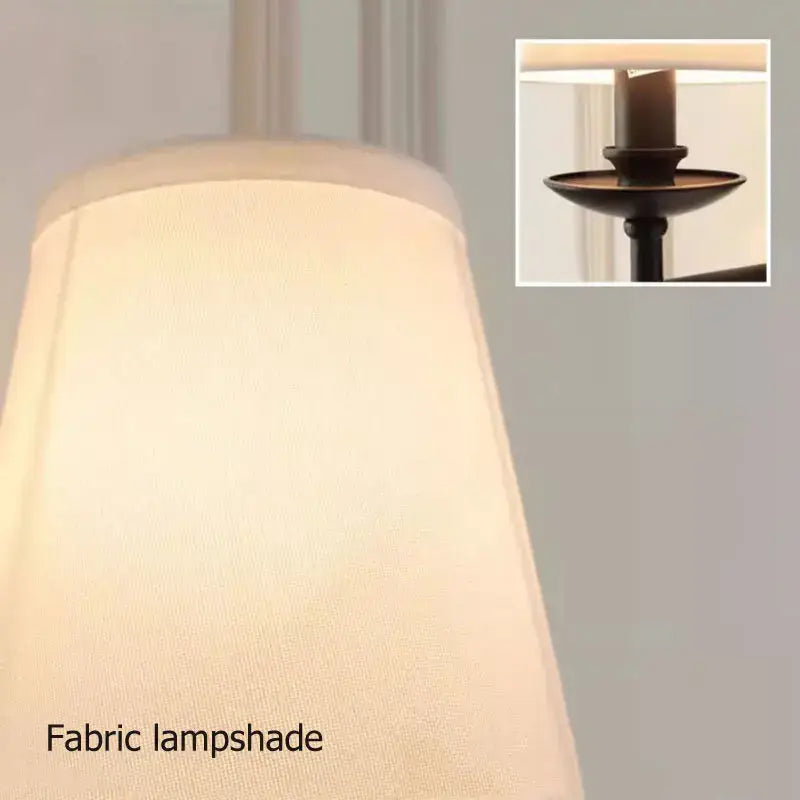 Cream-colored textured fabric lampshade with subtle sheen on decorbites black iron wall lamp for bedroom and living room