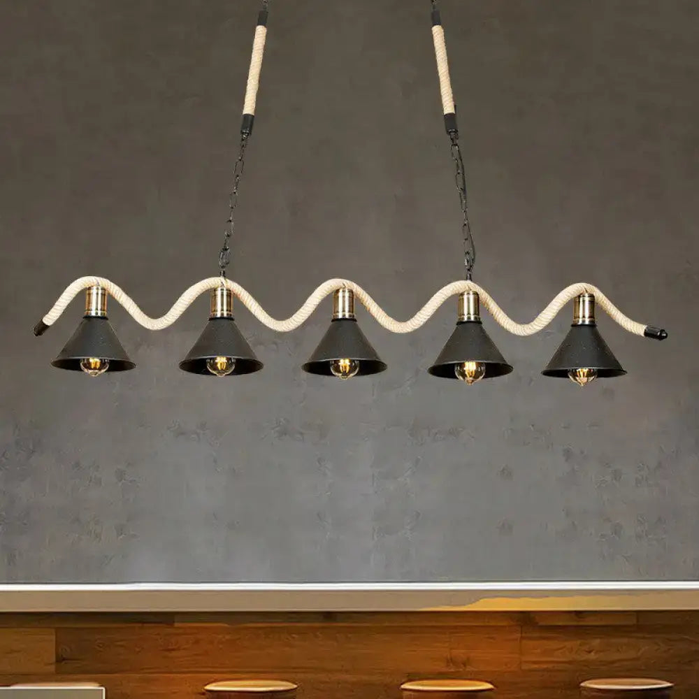 DecorBites black island pendant features five black metal shades suspended by hemp rope with brass accents