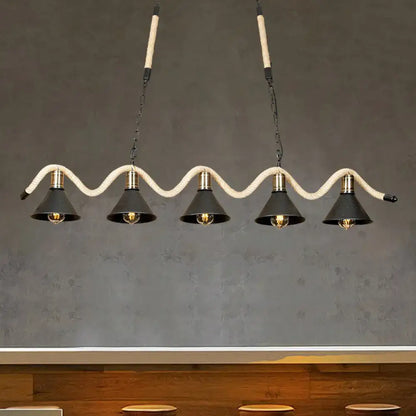 DecorBites black island pendant features five black metal shades suspended by hemp rope with brass accents