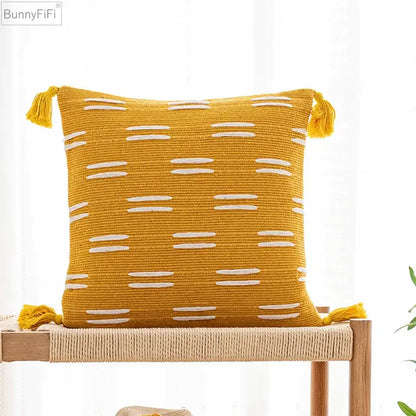 Yellow woven cushion cover with white stripes and tassels from decorbites black ivory for living room decor