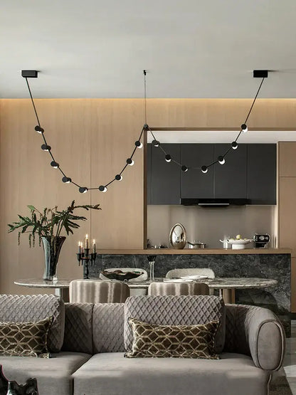 Modern black leather pendant light by DecorBites featuring spherical bulbs and minimalist design for dining room decor