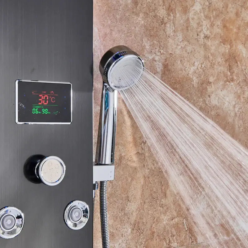 Chrome-finished handheld showerhead with water spray on decorbites black led waterfall rain shower panel