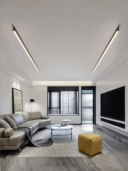 Yellow upholstered cube ottoman displayed under decorbites black linear led ceiling lamp for living room and dining area