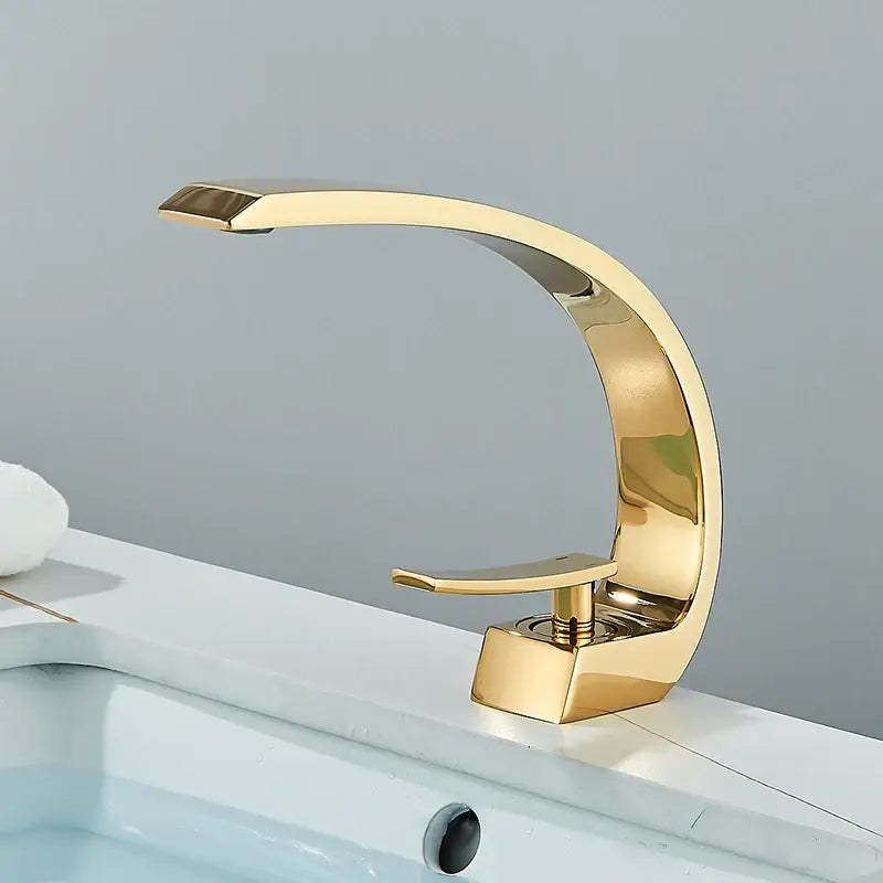 DecorBites™ black luxury brass basin faucet mixer tap with a gold-colored sleekly curved brass basin faucet design
