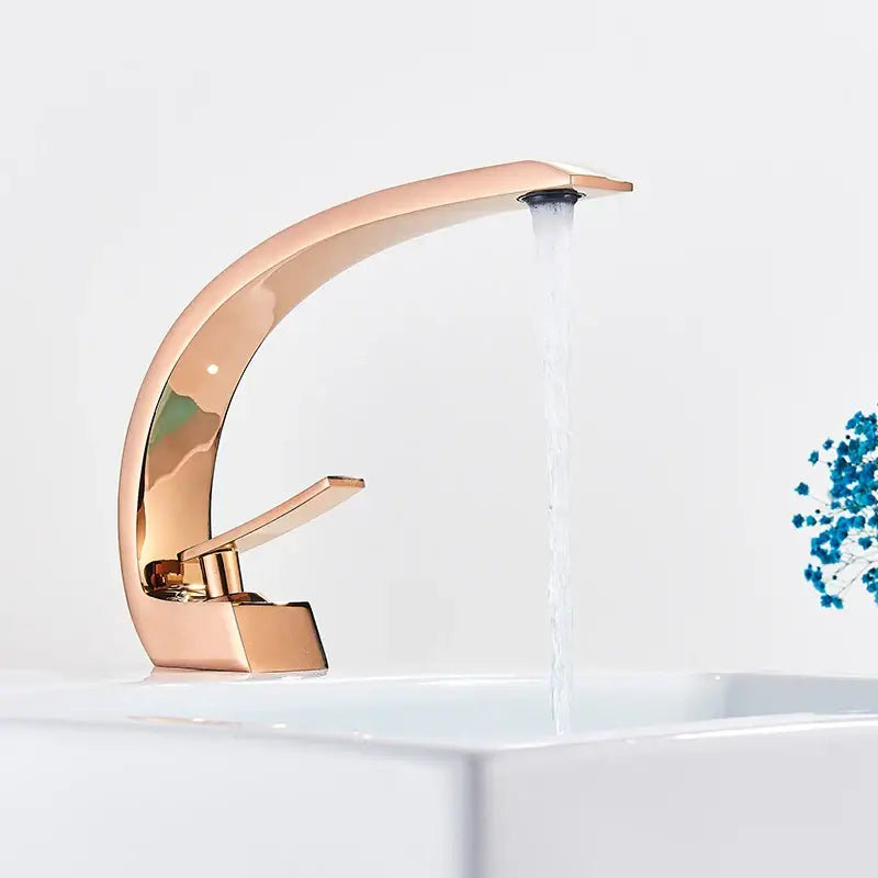 Rose gold arched basin faucet mixer tap with sleek modern design in luxury brass for elegant bathroom use