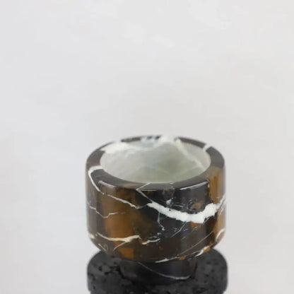 Decorbites black marble candle holder with polished cylindrical design featuring brown black marble and white veining