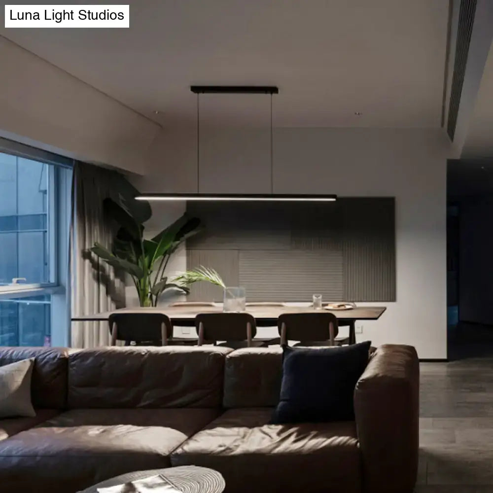 DecorBites™ black metal linear LED pendant light with remote control suspended above dining table