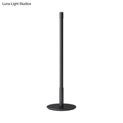 Black metal plumb rod LED night light with circular base, a sleek bedside table lamp from DecorBites™